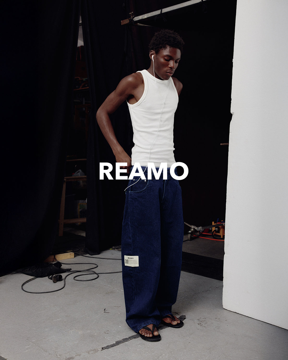 REAMO Denim lookbook – Sayeem raw denim with a white tank top backstage